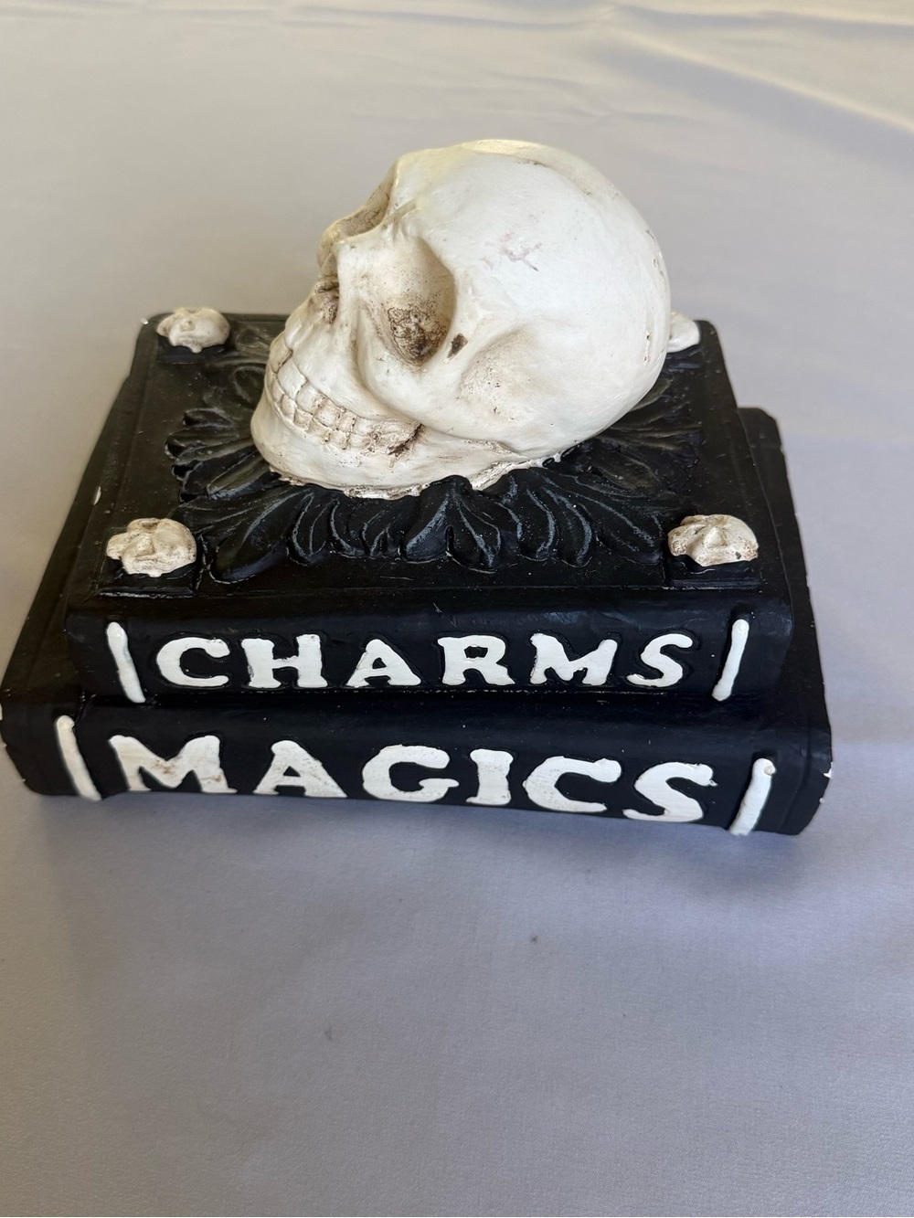 Halloween table decor white skull on top of spell books